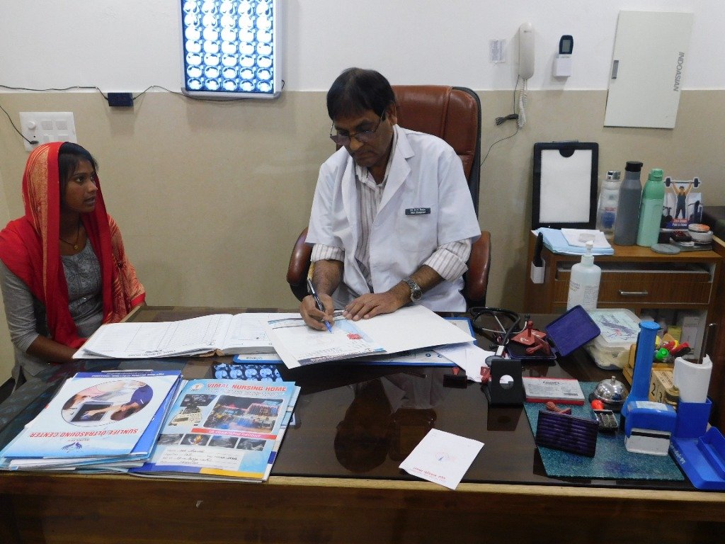 Dr. P.N. Parya consulting a patient