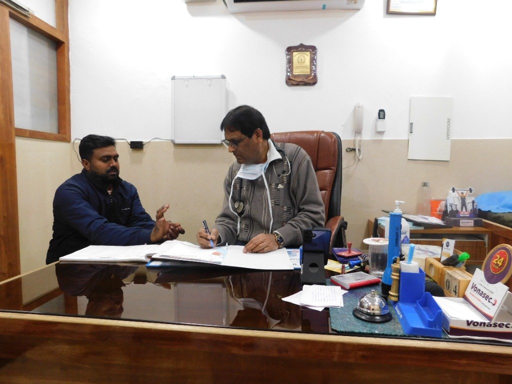 Dr. P.N. Parya consulting a patient